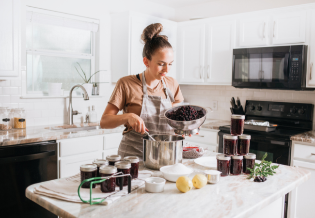 Young woman learning how to make preserves