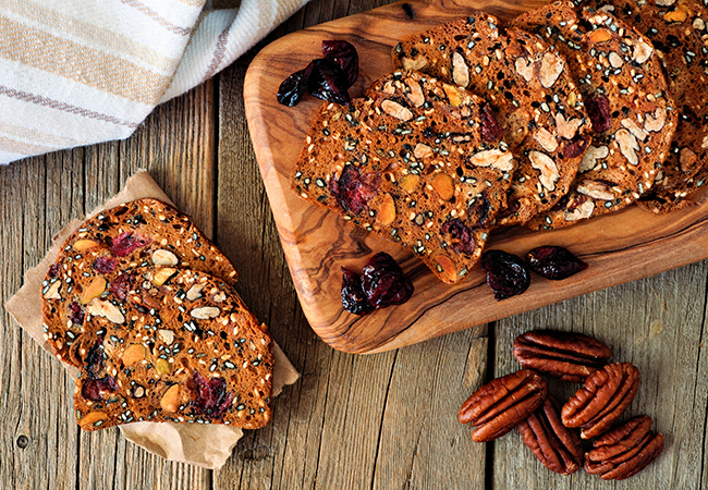 Baked crisp crackers with cranberries, nuts and seeds