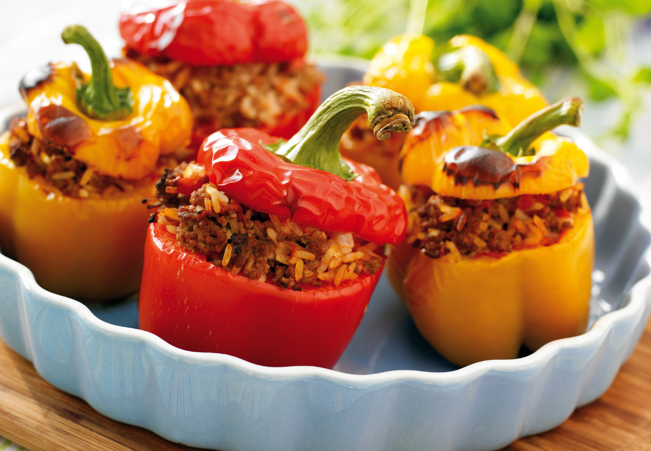 colorful bell peppers baking in a white ceramic dish