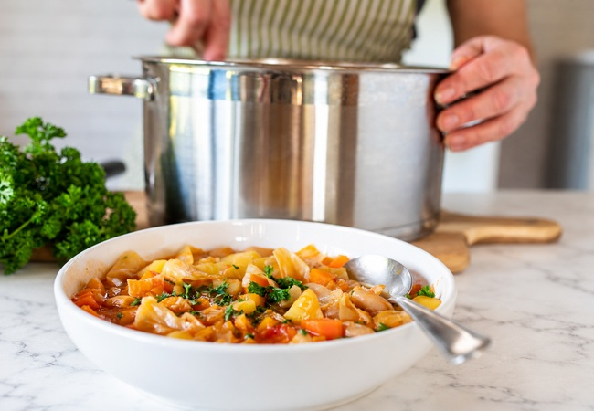 Pot of bean and vegetable soup sitting on counter